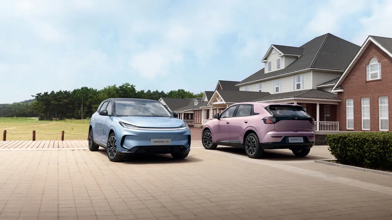 Two ARCFOX T1 parked in front of a house